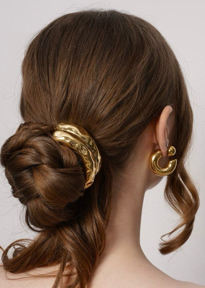 Celeste gold hoop earrings styled with a low bun and gold ponytail cuff, Luvertta
